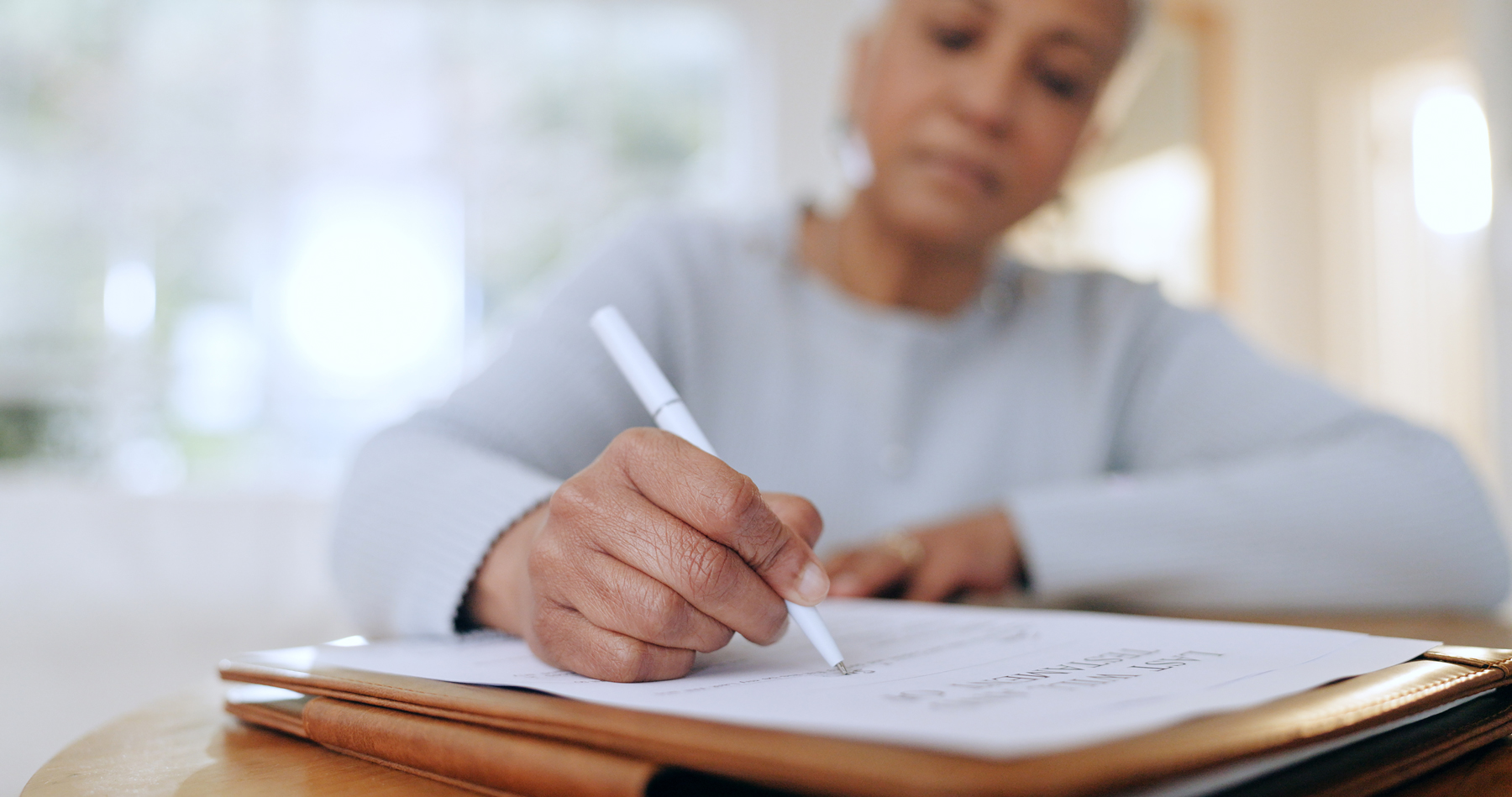 woman writing on a piece of paper